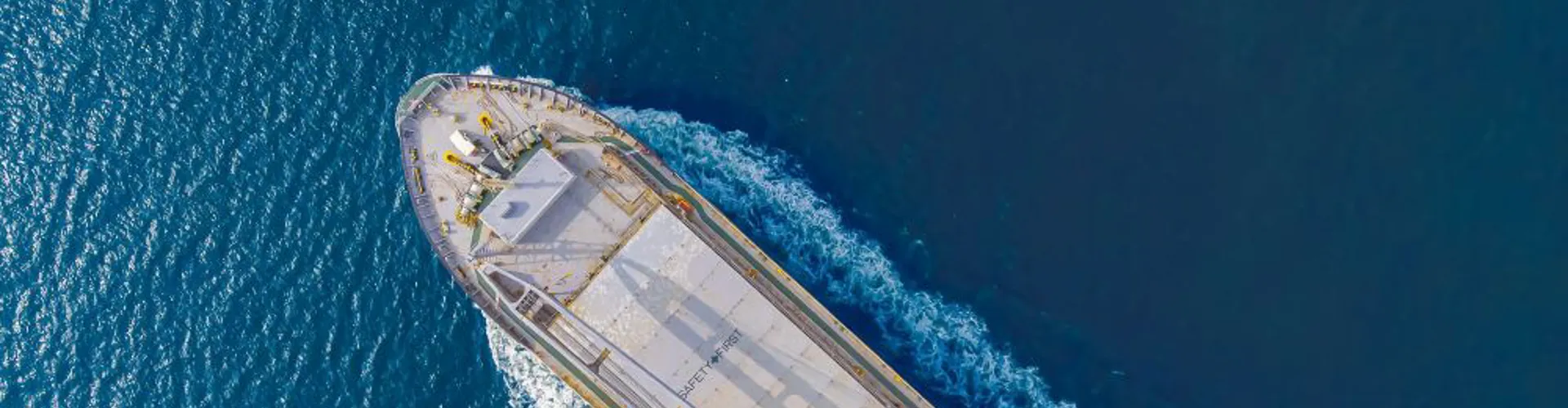 Aerial view of a cargo ship in blue water