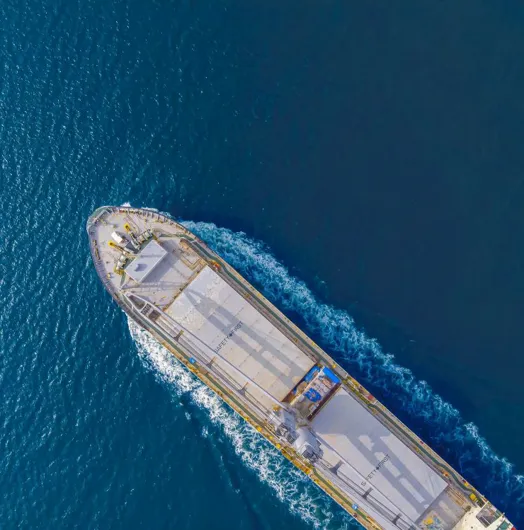 Aerial view of a cargo ship in blue water