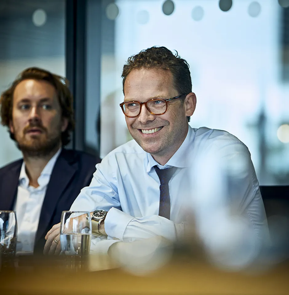 focus on a man smiling in a meeting