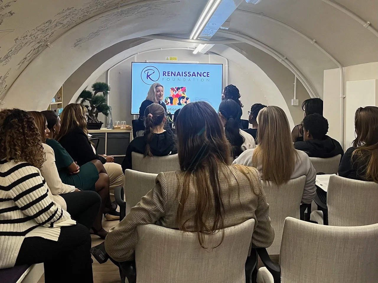 Group attending a presentation in a meeting room.