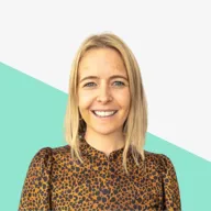 Smiling woman with blonde hair in a brown patterned blouse against a light background with a green shape.