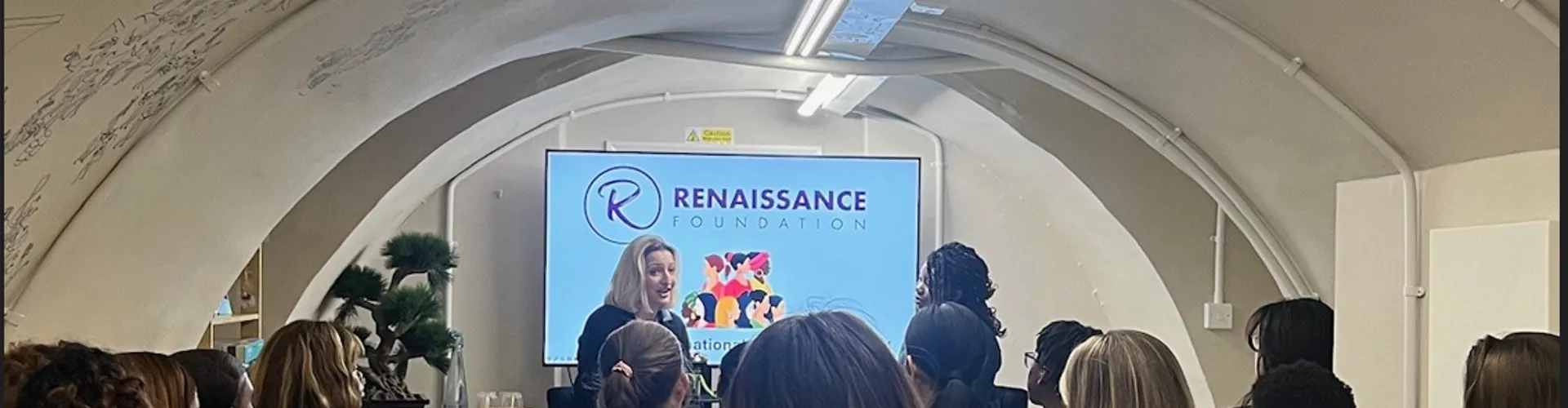 Women attending a presentation at a venue.