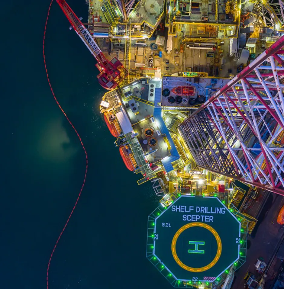 Aerial view of an oil drilling rig at night.