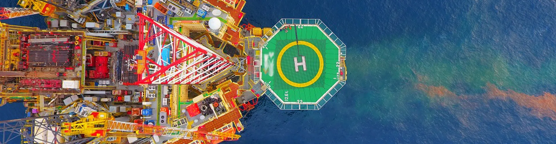 Aerial view of an offshore oil rig and helipad.