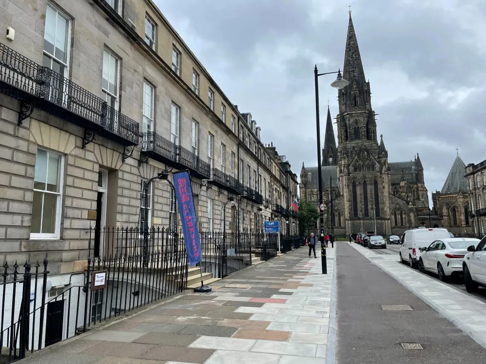 Street scene with historic buildings and a church.