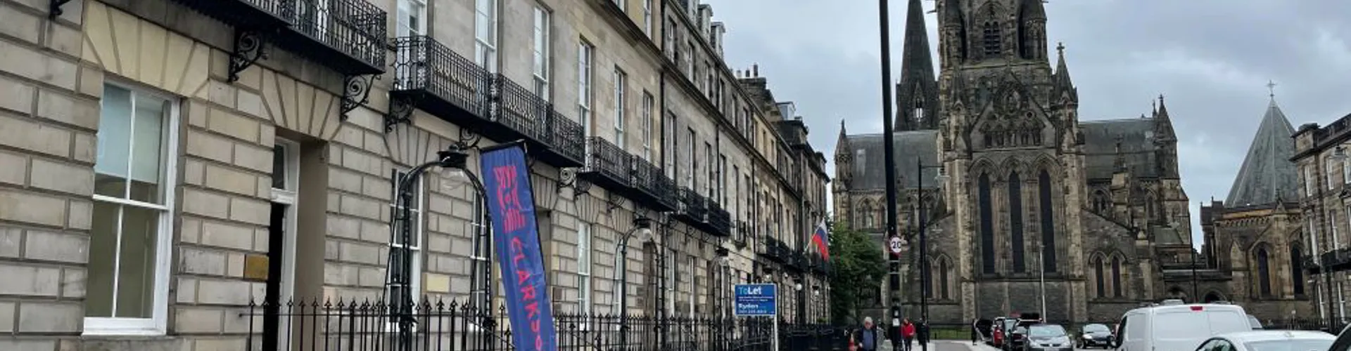 Street scene with historic buildings and a church.