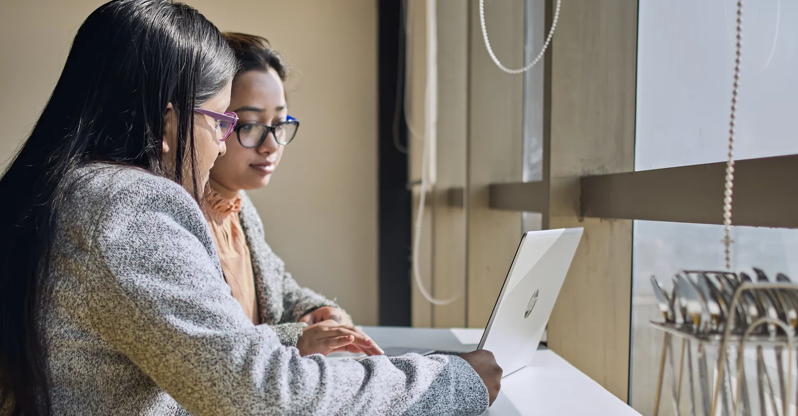 Two women looking at laptop