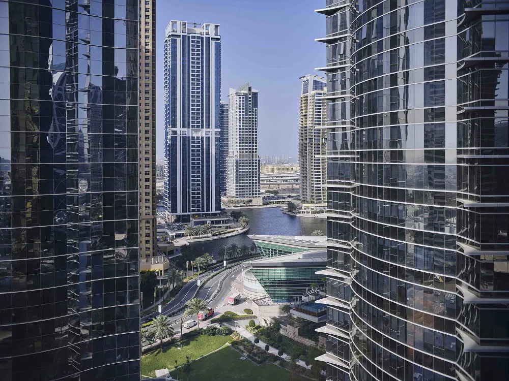 Cityscape with modern skyscrapers and waterway.