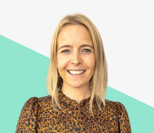 Smiling woman with blonde hair in leopard print top.