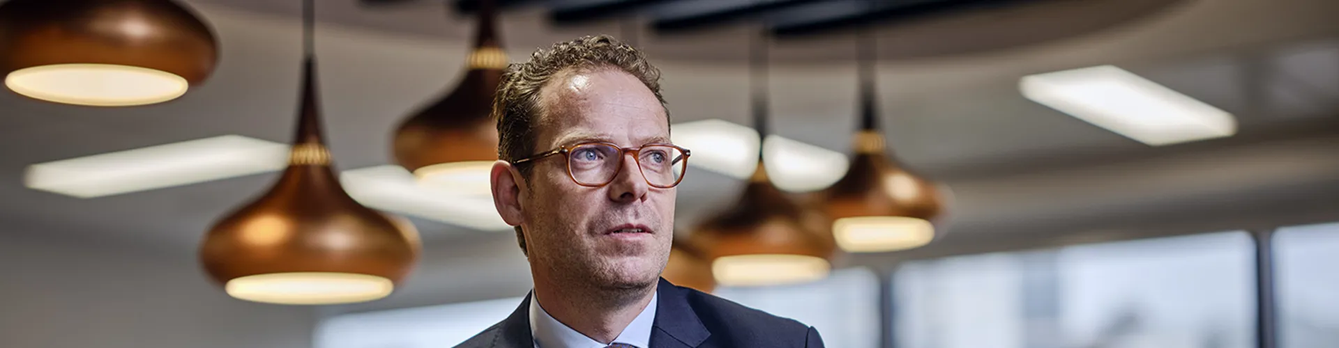 Duncan Lyall, head of carbon credit broking gesturing to others in a board room