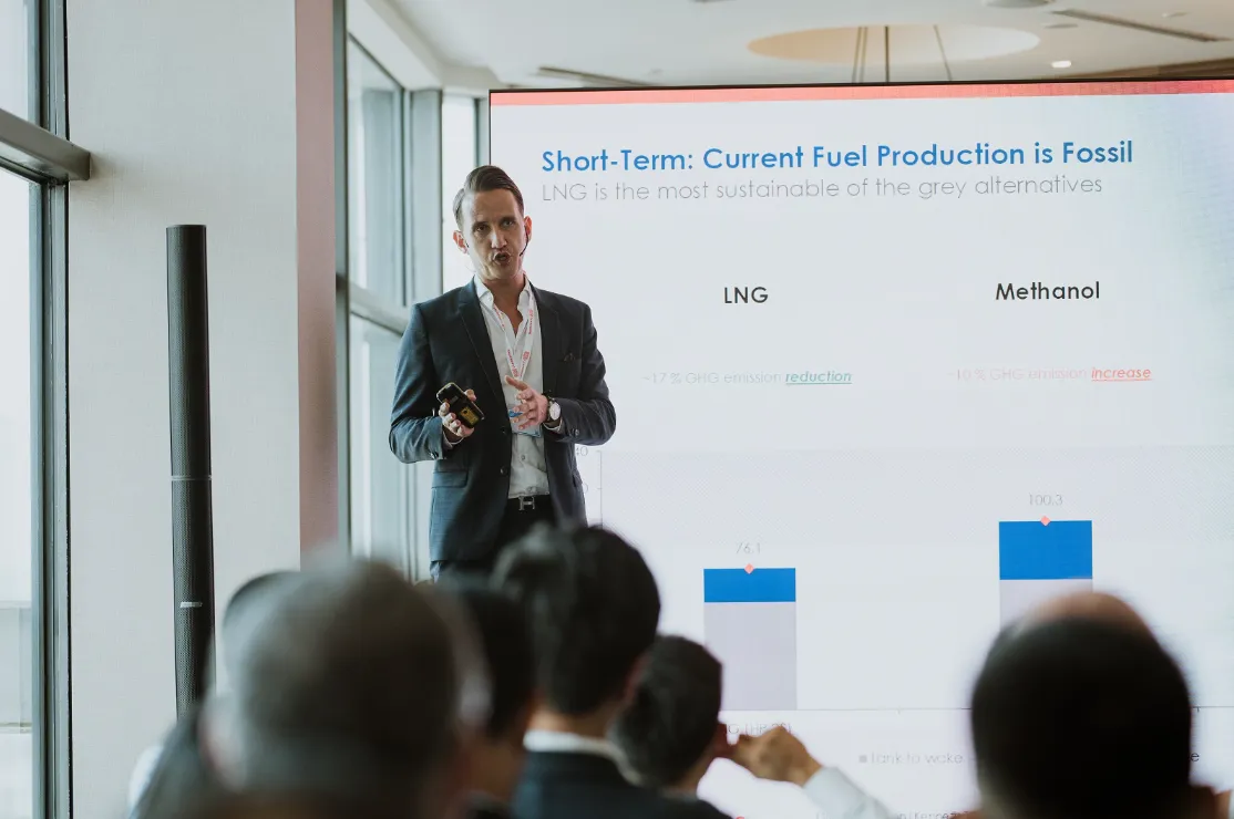 Presenter discusses fuel production with a chart.