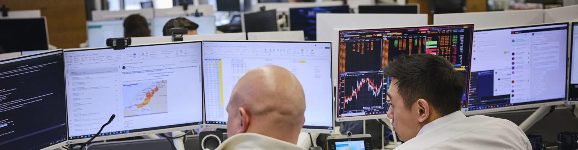 two men discussing work at their computer
