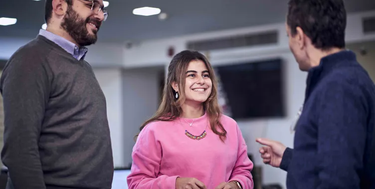 two men and a woman talking 