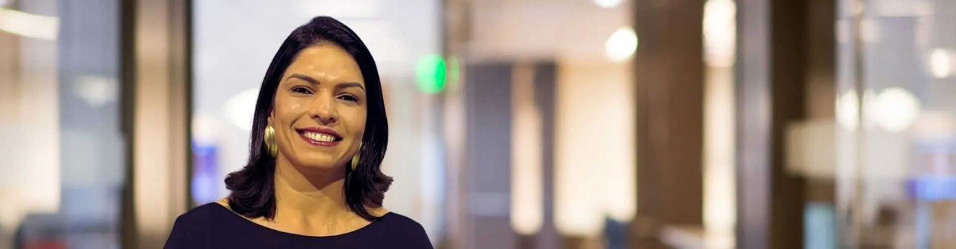 Smiling woman in a professional office setting.