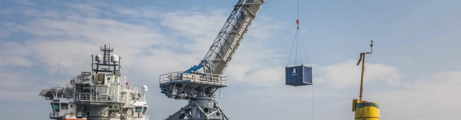 Cargo ship with crane lifting container at sea.