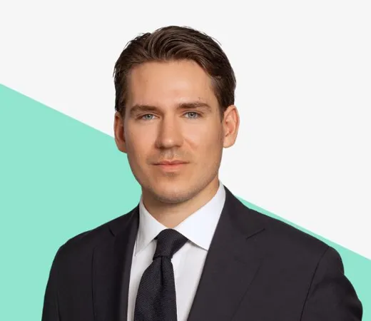 Person in a suit and tie against a light background with a teal diagonal shape.