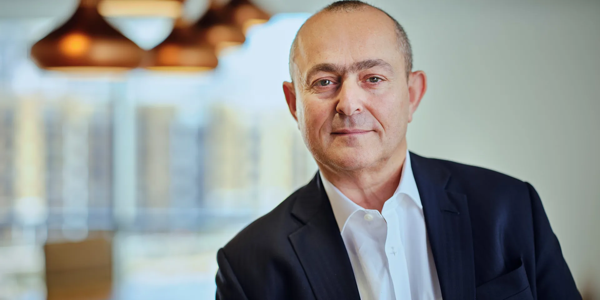A man in a suit in an office setting.