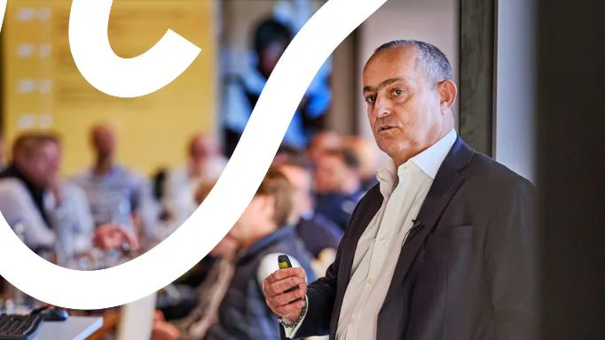 Speaker presenting to an audience in a conference.