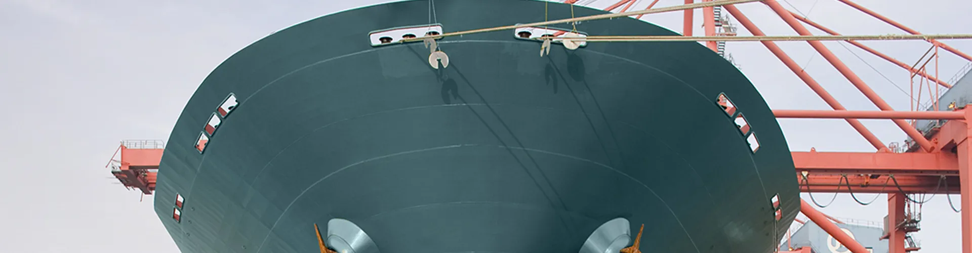 Bow of a red and teal cargo ship