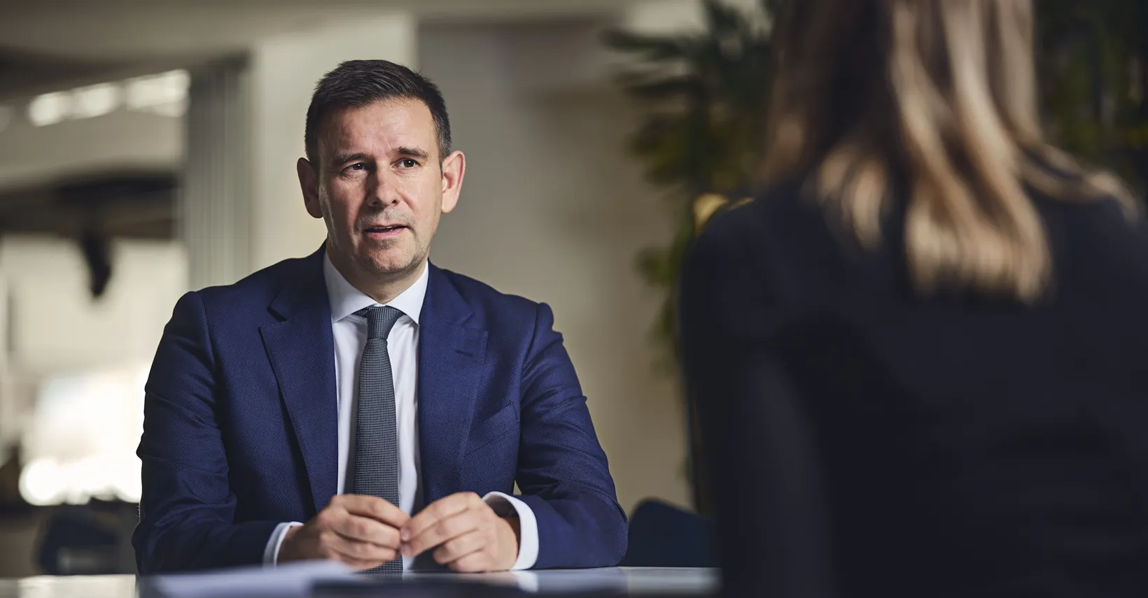 man talking to someone across a table