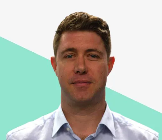 Man with short hair wearing a light blue shirt.