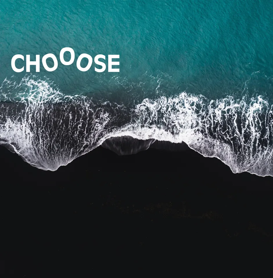 Ocean waves meet a dark shoreline, with text.