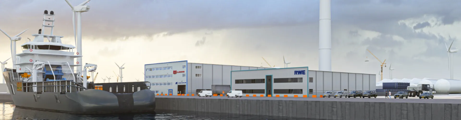 Large ship docked at a port near industrial buildings and wind turbines.